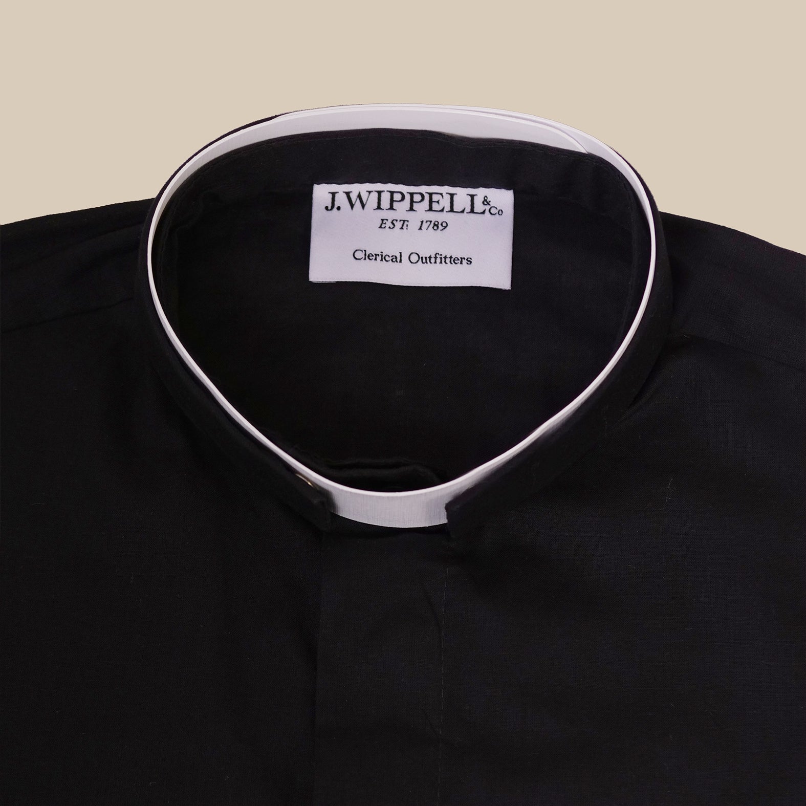 Close-up of the collar of a Women's Tonsure Clergy Shirt by J. Wippell showcasing the brand label.